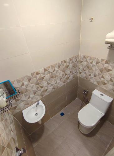 a bathroom with a toilet and a sink at Lembah Saerah Resort in Kangar