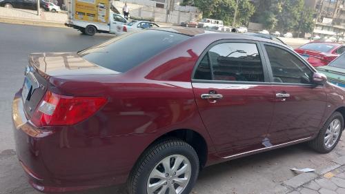 un coche rojo estacionado al lado de una calle en Renting a private car with private driver, en El Cairo