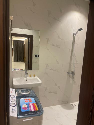 شقق درر رامه للشقق المخدومة 10 في الرياض: حمام مع حوض ومرآة