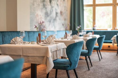 a dining room with tables and chairs with wine glasses at Biohotel Leutascherhof in Leutasch