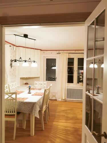 a kitchen and dining room with a table and chairs at Hus nära havet in Bergkvara