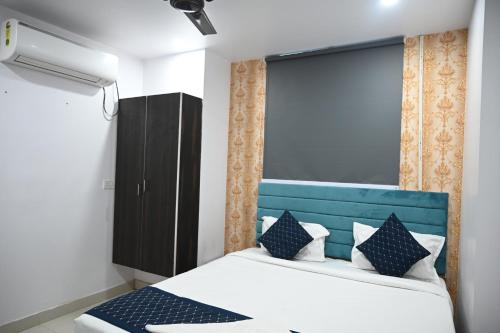 a bedroom with a bed with a blue headboard at HOTEL DIAMANT INN in Patna