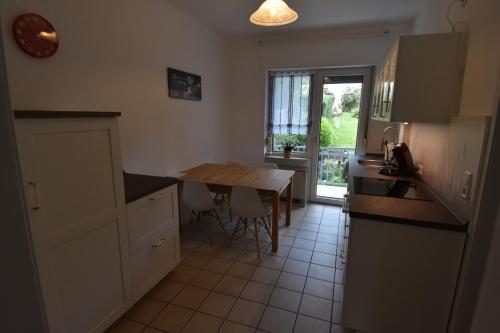 a kitchen with a table and a dining room table at Ferienwohnung Hohenlimburg in Hagen