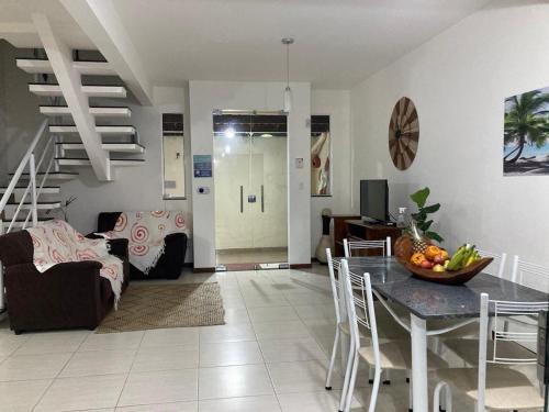 a living room with a table and a couch at Casa Brisas Arembepe - arejada e aconchegante - litoral norte da Bahia com crianca - WiFi in Arembepe