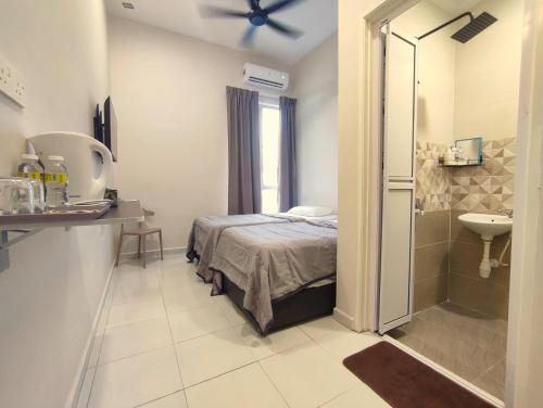 a bedroom with a bed and a shower and a sink at Lembah Saerah Resort in Kangar
