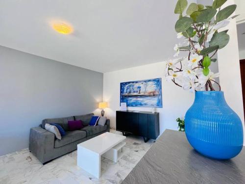 a living room with a large blue vase at Le Pinède - Apt 4 Prs- Parking - Clim - 500m plages in Antibes