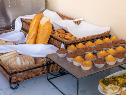 two baskets of bread and pastries on a table at S Plaza Suites Hotel in Seef