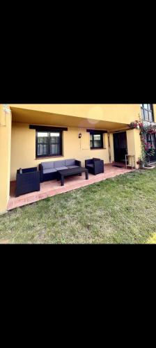 a building with two blue couches in a yard at El Acebu in Colombres