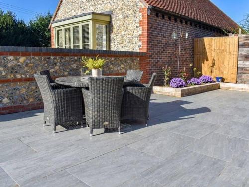 a patio with a table and chairs on a patio at Blundens Holiday Lets - Hatfield in Chichester