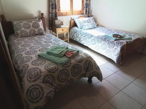 a bedroom with a bed and a table with towels at Despina country retreat in Paphos City