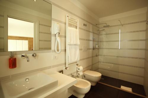 bagno bianco con lavandino e servizi igienici di Hotel Fantasy a Riccione