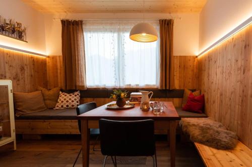 a living room with a table and a couch at Stadtfüchse plus Sauna in Bad Ischl