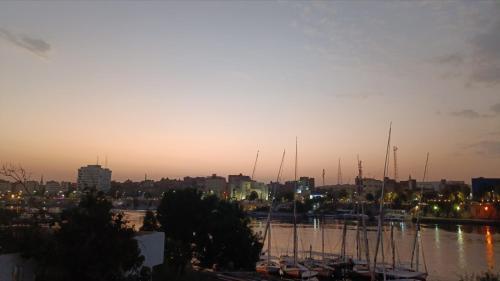 a group of boats parked in a marina at sunset at Bakar Nubian Guest House in Aswan