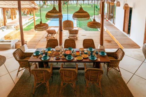 a dining room with a table and chairs at Villa Onu Mentawai - Private Rooms in Katiet
