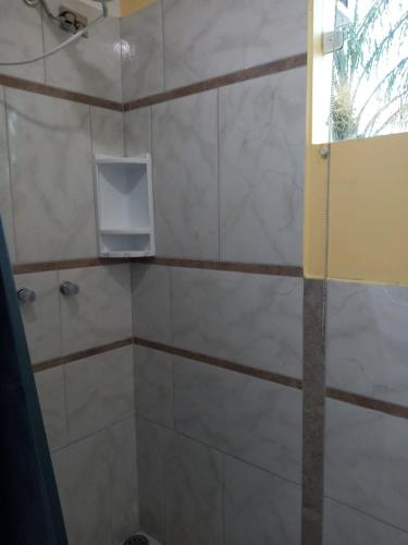 a bathroom with a shower with a window at Solar do Forte Flats in Ubatuba