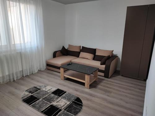a living room with a couch and a coffee table at A&A Residence in Piatra Neamţ