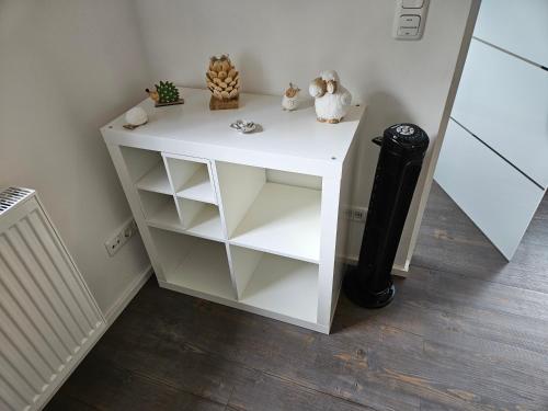 a white cabinet with shelves and stuffed animals on it at Ferienwohnung Klettham in Erding