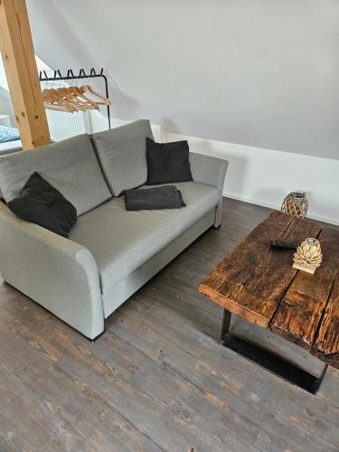 a living room with a couch and a wooden table at Ferienwohnung Klettham in Erding