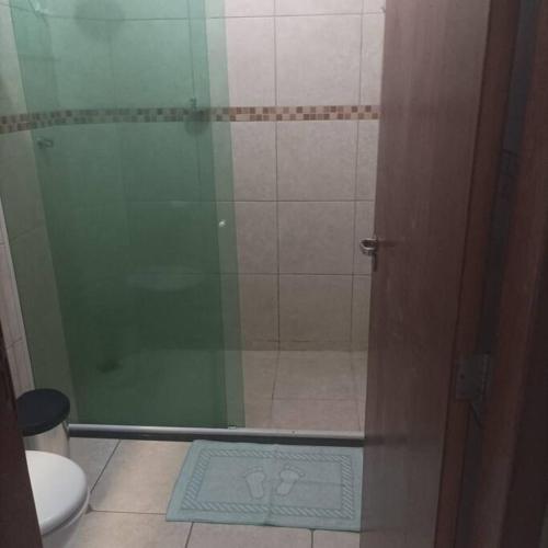 a bathroom with a shower with a glass door at Casa Jardim Belvedere VR in Volta Redonda