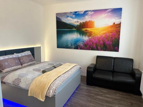 a bedroom with a bed and a painting on the wall at O2 Aréna -PVA expo - Tomy Apartment -Praha in Prague