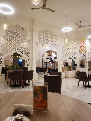 a lobby with a table and chairs and a restaurant at Yugeen Airbnb in Mombasa