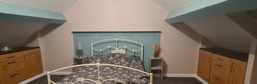 a bedroom with a bed with a blue cabinet at Charming 1-Bed Apartment in Barnsley in Barnsley
