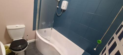 a bathroom with a toilet and a shower with a phone at Charming 1-Bed Apartment in Barnsley in Barnsley