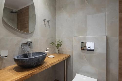 a bathroom with a sink and a mirror at Diva Lodge in Sikia