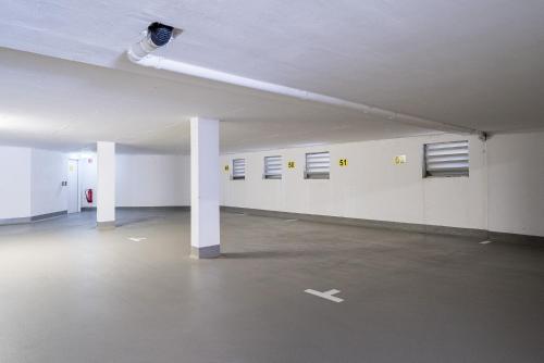 an empty parking garage with white walls and windows at Apartment 104 in Feldberg
