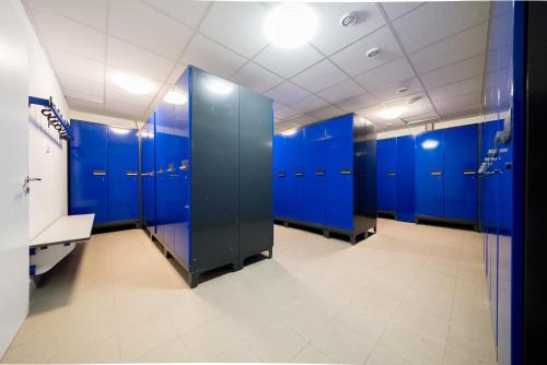 a row of blue stalls in a bathroom at Apartment 104 in Feldberg