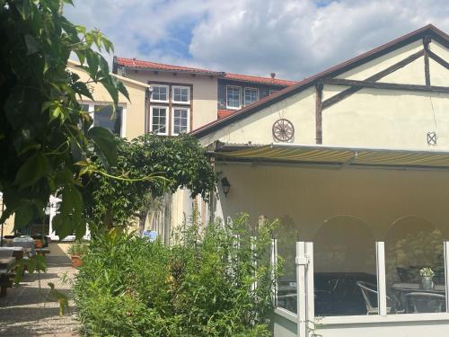 a house with a garage and a building at Harzhotel Warnstedter Krug in Thale