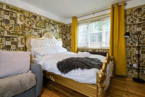 a bedroom with a bed and a wall covered in wallpaper at Lux 2 Bed Versace Bungalow Hot Tub, Sky TV, Cinema Screen Saffron Walden in Saffron Walden