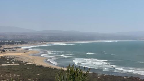 an aerial view of a beach and the ocean at Dar Bouba, Cap Sim : la maison sur l'Océan in Wassane