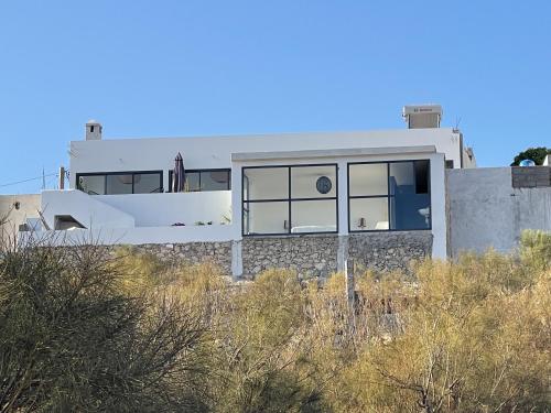 a house on top of a hill with grass at Dar Bouba, Cap Sim : la maison sur l'Océan in Wassane