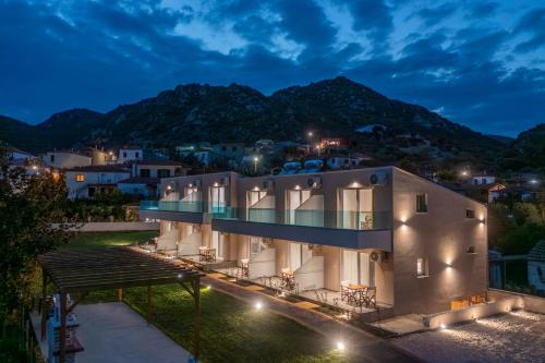 a view of a building at night at Diva Lodge in Sikia