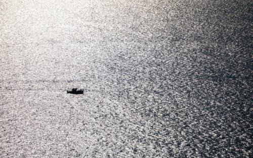 a boat in the middle of a large body of water at Diva Lodge in Sikia