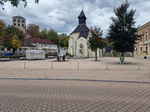 a small church with a tower in a courtyard at Gudzevic FU A - 5 in Gloggnitz
