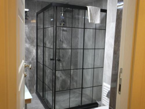 a shower with a glass enclosure in a bathroom at ANKUVA HOTEL in Ankara