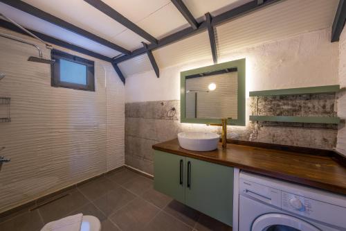 a bathroom with a sink and a mirror at villa calippo in Antalya