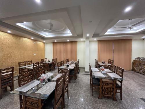 a dining room with wooden tables and chairs at Fair Mount in Srinagar