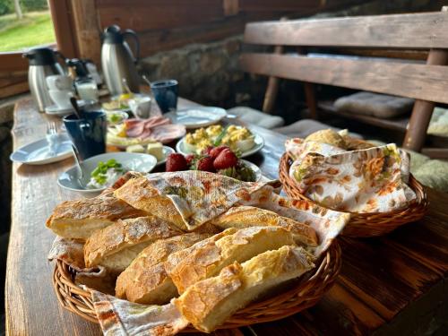 una mesa con una cesta de pan y platos de comida en Izerska Chata pokoje gościnne, en Świeradów-Zdrój