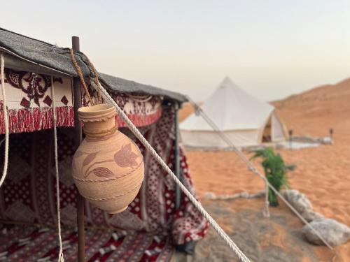 a vase hanging from the side of a building at Thousand Stars Desert Camp in Bidiyah