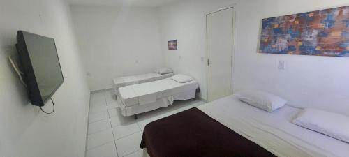 Кровать или кровати в номере Santorini Praia Hotel