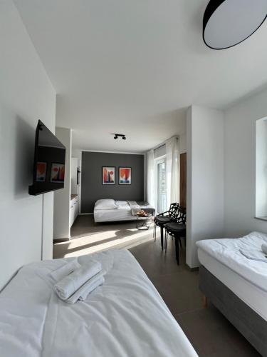 a bedroom with two beds and a flat screen tv at BnB Open Apartments Pader-Chill in Paderborn