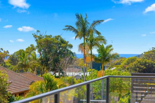 a view from the balcony of a house with palm trees at 'Beautiful View' close to Flynns Beach in Port Macquarie