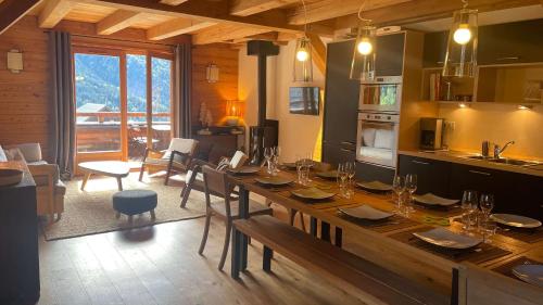 une cuisine et une salle à manger avec une grande table en bois dans l'établissement Chalet Skidh - 10 personnes - emplacement idéal au centre de Vaujany, à Vaujany