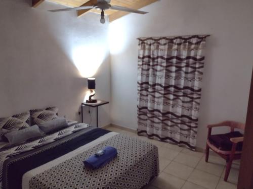 a bedroom with a bed and a ceiling fan at A&M Alojamiento - Lluvia de Oro 2554 in Puerto Rico