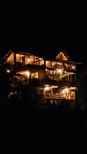 a lit up house at night with lights at Sunils Cabin 5BHK Glass View Villa Manali in Shirir