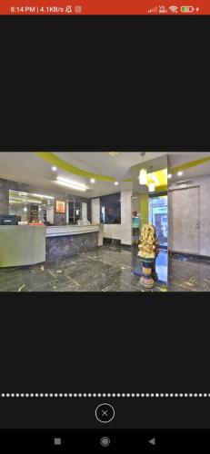 a picture of a lobby with a counter in a building at HOTEL SURYAKANT in Rajkot