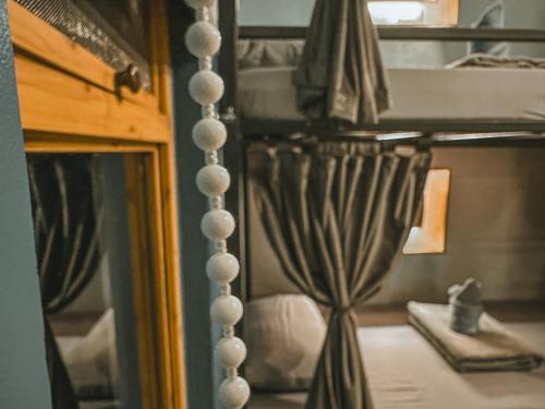 a reflection of a bedroom with a bunk bed at Outpost Hostel - Coron in Coron